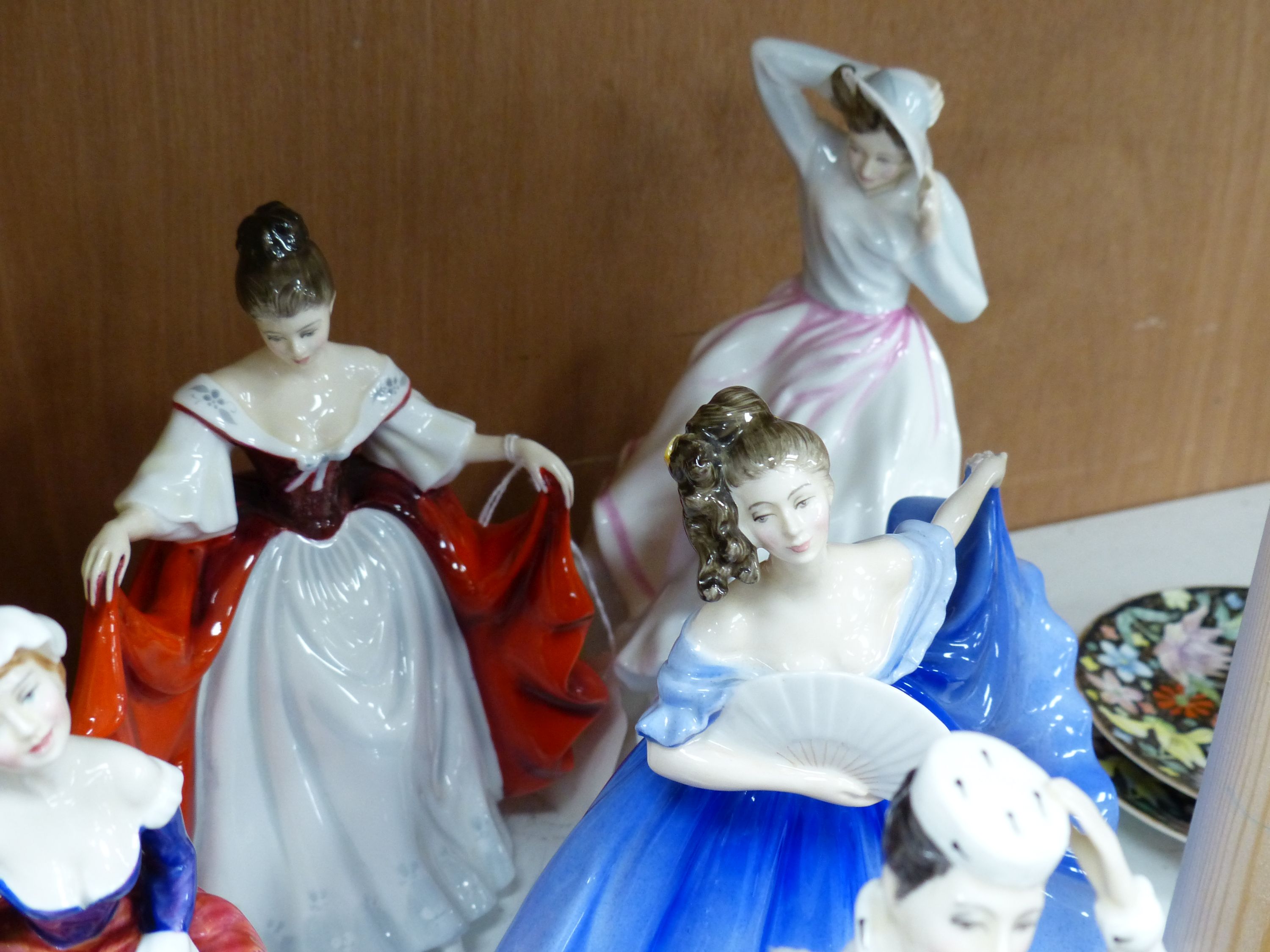 Ten Royal Doulton figurines, including 'Sara', 'The Judge', 'The Old Balloon Seller', 'Elaine' and others